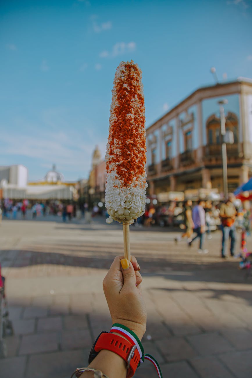 a person holding an elote